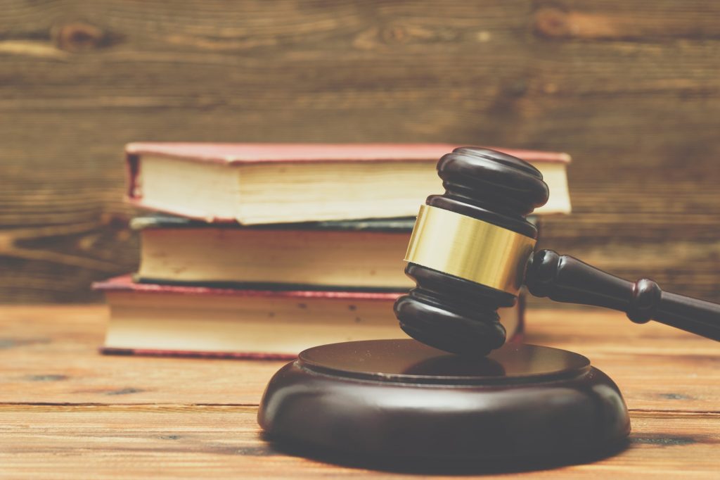 Gavel and law books on a wooden background